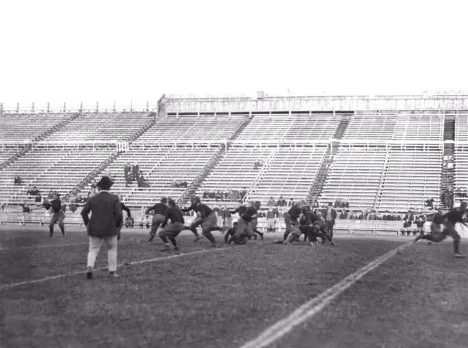 New Haven, Connecticut:  c. 1913 The Yale football team at practice. The quarterback is preparing to throw the ball.