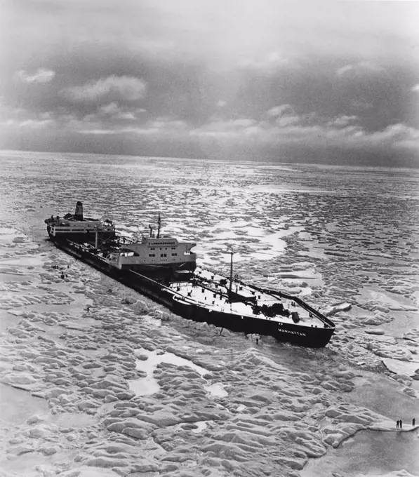 Canada:   November, 1969 The SS Manhattan, an oil tanker outfitted with an icebreaker bow, as she crosses the Northwest Passage in the Arctic. The ship is 1005 feet long, and its beam was increased form 132 feet to 148 feet by the addition of a protective "ice belt" to guard against hull penetration by the icebergs encountered on the expedition. The icebreaking bow added 65 feet to her length.