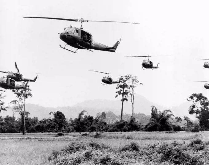 Vietnam:   c. 1967 A flight of Hueys moves into the landing zone to disembark its troops. Each one hovers less than six seconds as the troops hit the ground running and disappear among the trees.