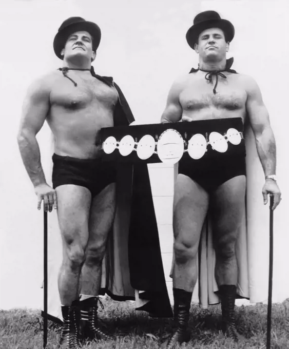 United States:  c. 1962 Professional wrestlers Magnificent Maurice (Gene Dubuque) and Handsome Johny Barend pose for a promotional poetrait.