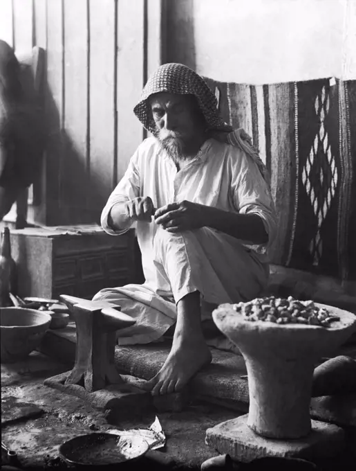 Baghdad, Iraq:  1932 A Sabean silversmith at work in his jewelry store.