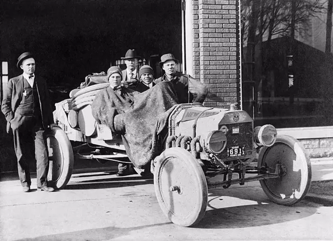 Flora, Indiana:  1917 Two college students are prepared for a cold ride in an open car.