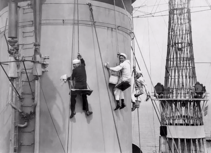 United States:  c. 1919 U.S. Navy sailors cleaning the stacks on the super-dreadnaught battleship, the USS Pennsylvania.