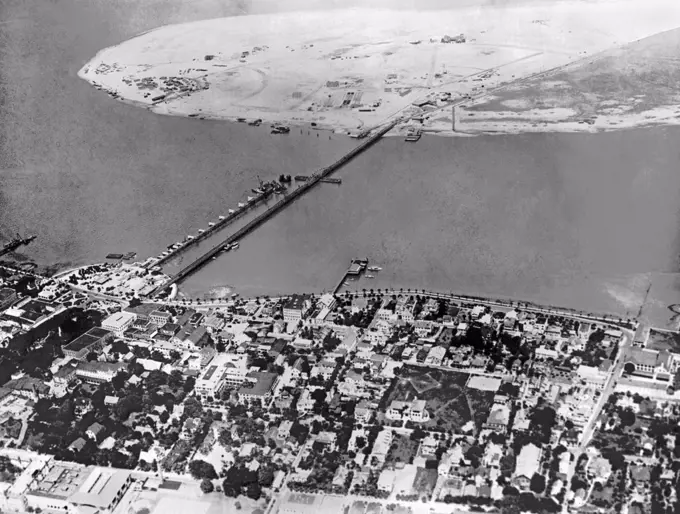 St. Augustine, Florida  July 12, 1926 Eight months ago the island at the top of the photo was prime oyster beds in Matanzas Bay in St. Augustine. Developer D.P. Davis dredged up 13,000,000 cubic yards of seafloor to produce this island which he will develop into real estate. The city paid for the new Anastasia Bridge to the island.