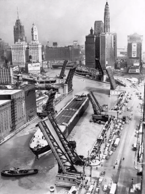 Chicago, Illinois:  September 3,  1953 The drawbridges are up for the arrival  of the former troop transport ship, "The Marine Angel". The ship was towed up the Mississippi River to Chicago and on to Lake Michigan where it was refurbished as a self unloading barge.