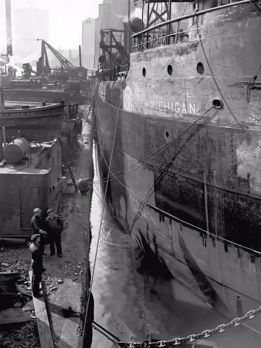 Chicago, Illinois:  c. 1928  The steel freighter, "Michigan", getting a spring cleaning and a fresh coat of paint in the shipyards at South Chicago.