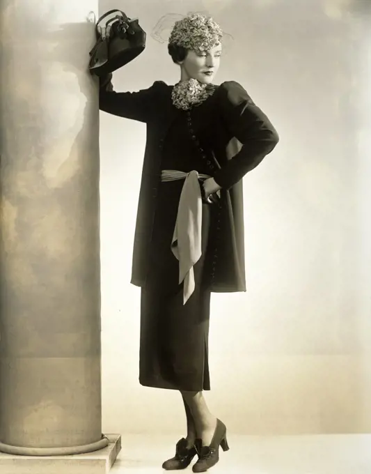 Young woman standing with her hand on her waist