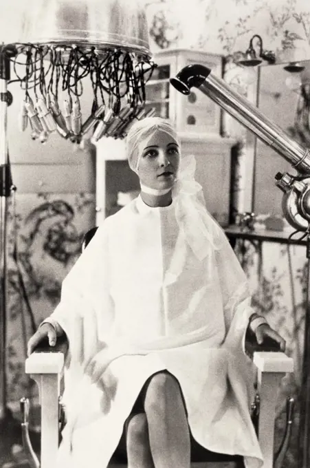 Young woman getting her hair dried in a hair salon