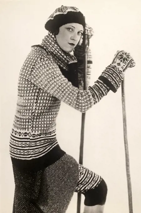 Portrait of a young woman holding a ski pole