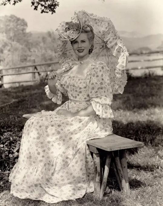 Portrait of a young woman holding a parasol