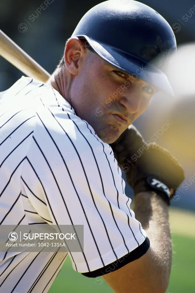 Close-up of a baseball player swinging a baseball bat