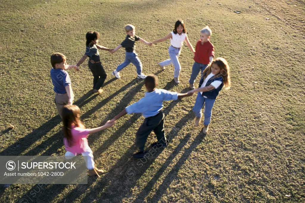 High angle view of a group of boys and girls playing together - SuperStock