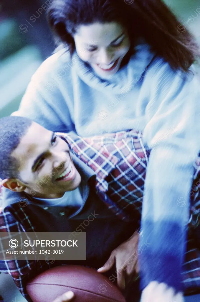 High angle view of a young couple playing football