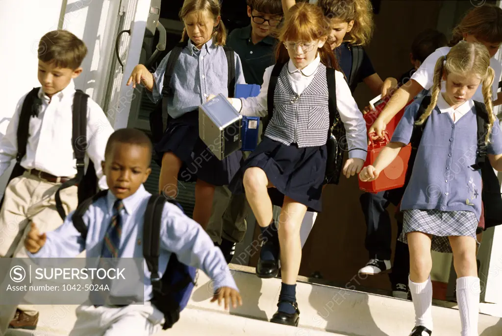 Students running down the school steps