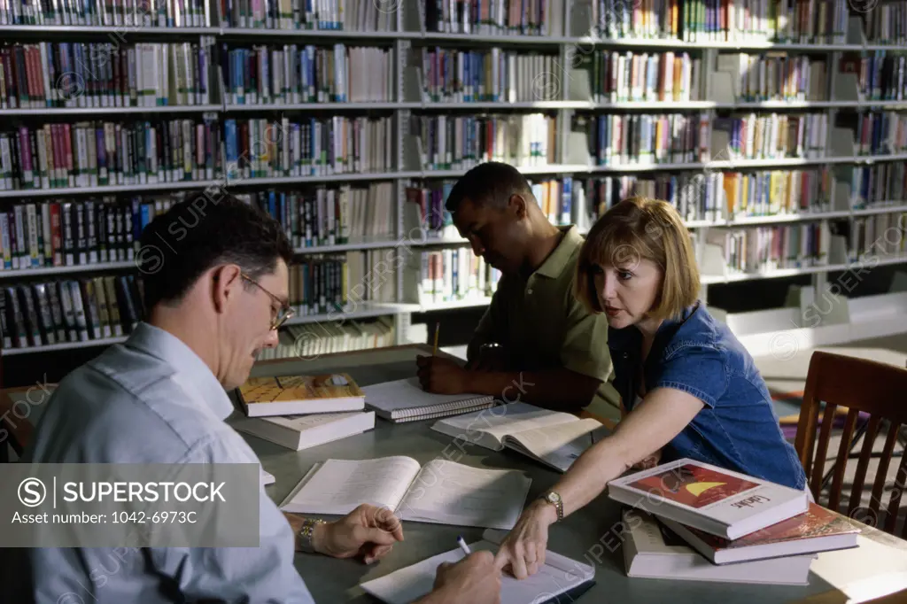 Adults studying in a library