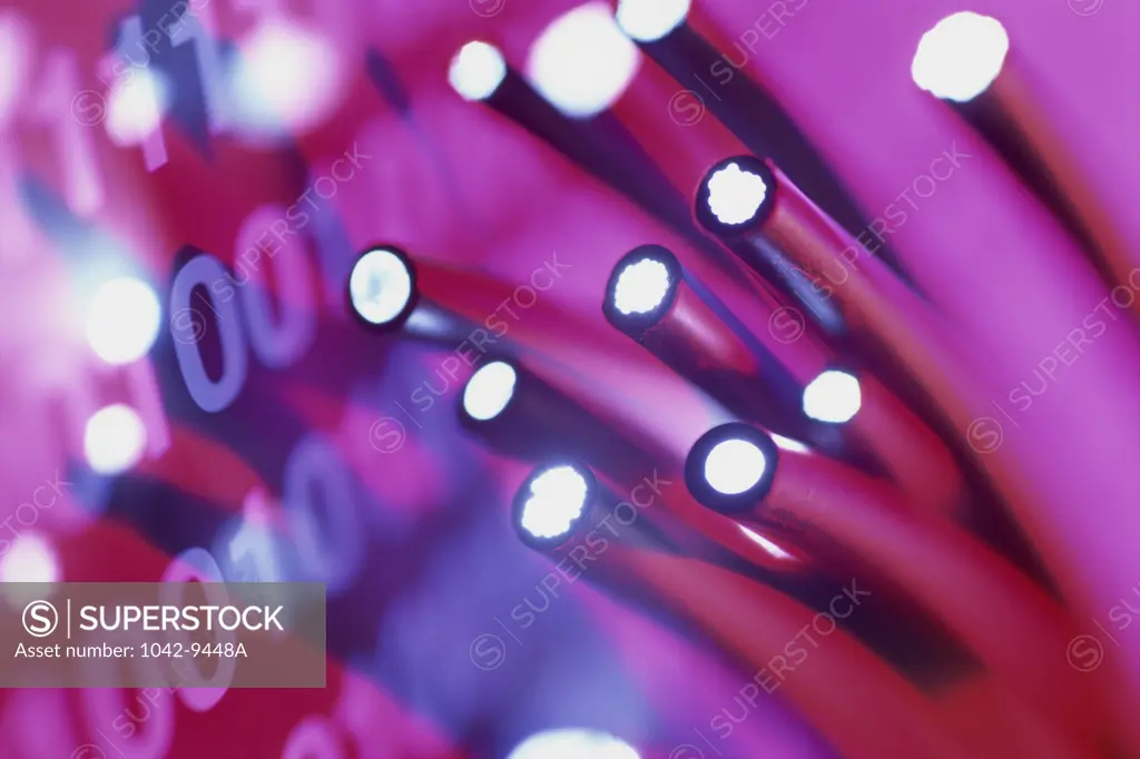 Close-up of fiber optics cables with binary code