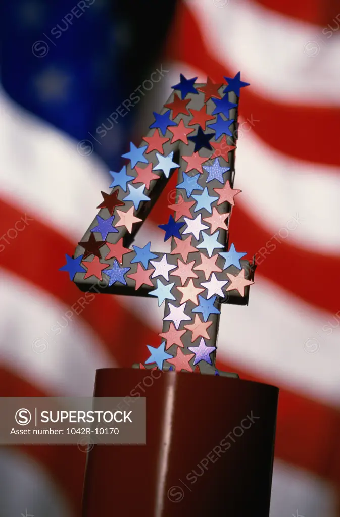 Number four covered with stars and the American flag in the background