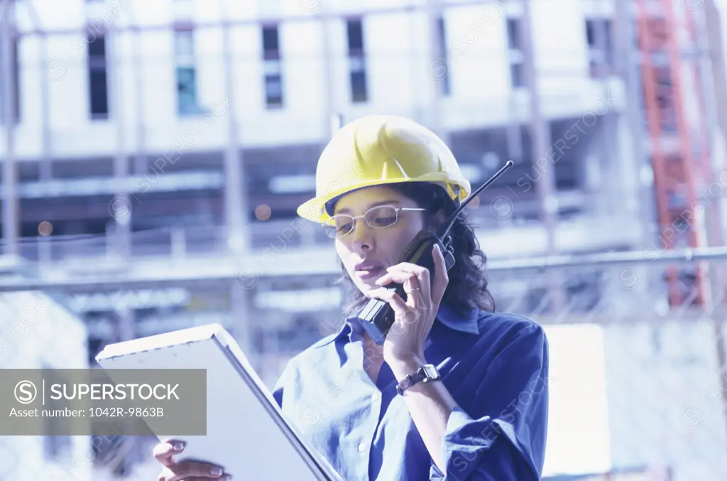 Forewoman talking on a walkie-talkie