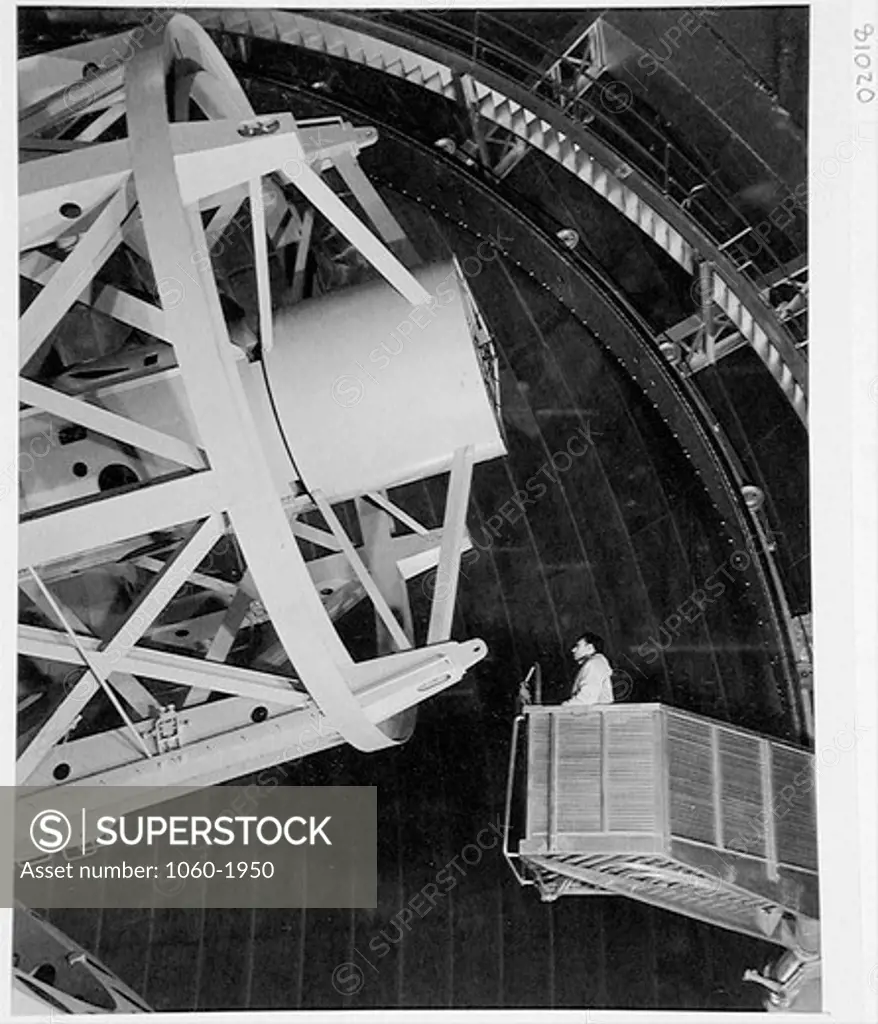 OBSERVER RIDING ELEVATOR TO 200-INCH TELESCOPE PRIME FOCUS CAGE.