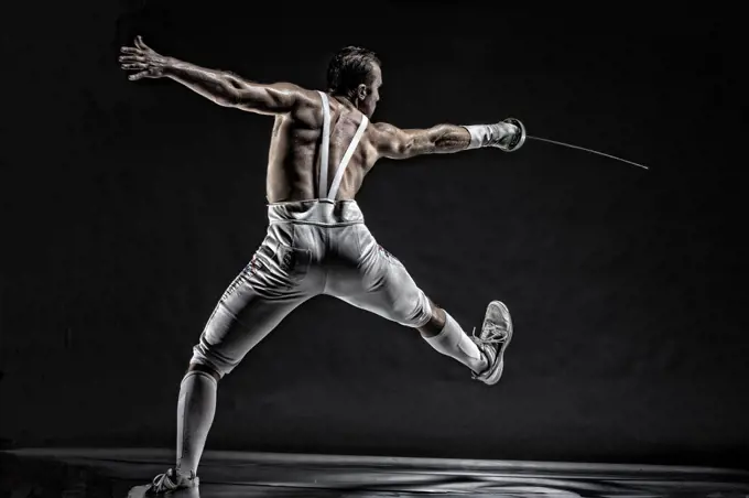 American World Champion and two time Olympic Fencer Soren Thompson against a dark background. Bodies in Action