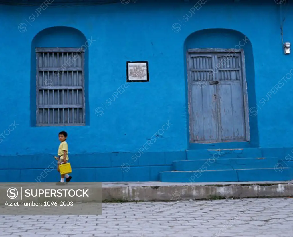 Boy standing on the sidewalk, Guatemala