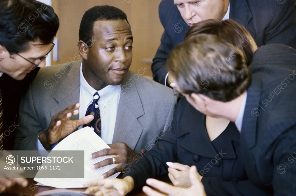 Group of business executives talking in an office