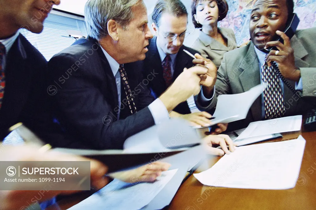 Group of business executives talking in an office