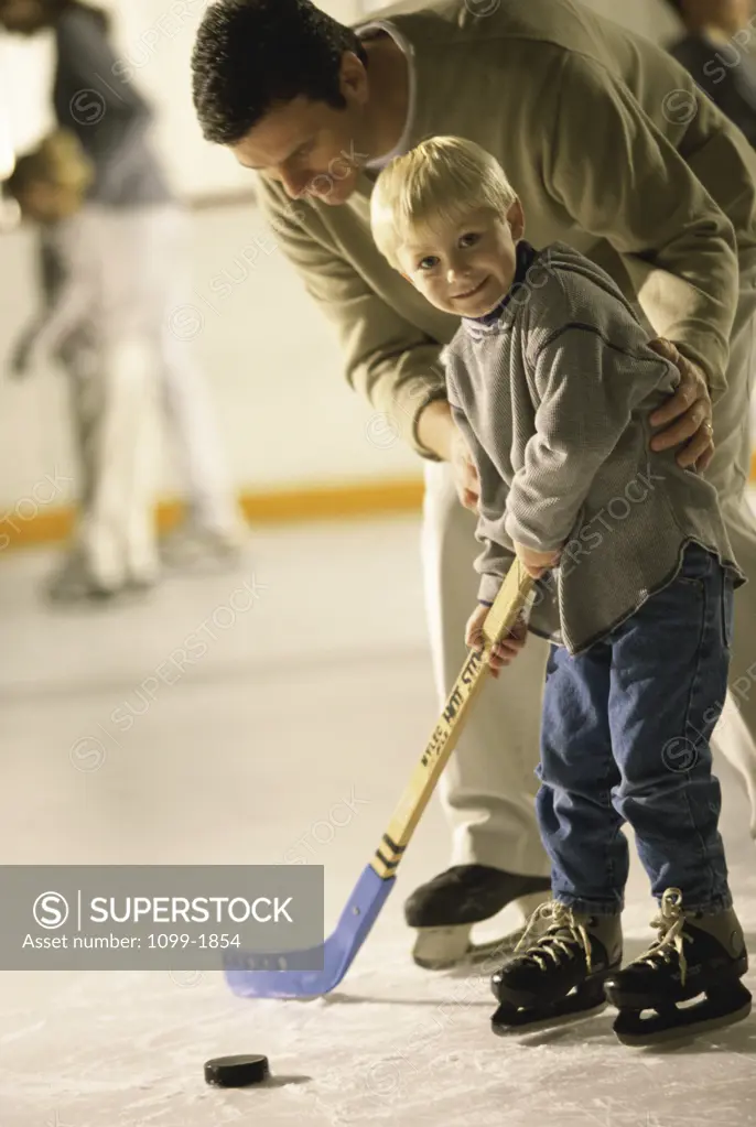 Father teaching his son hockey