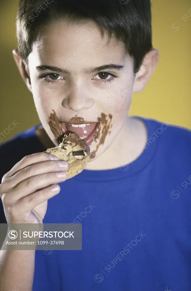 Portrait of a boy eating a cookie