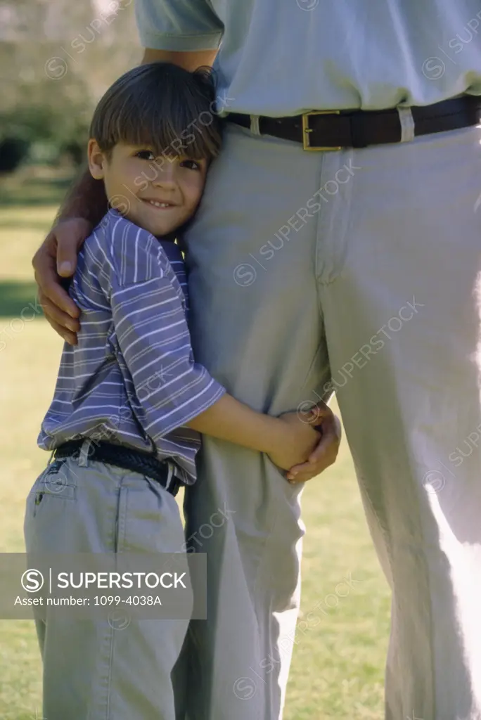 Son holding his father's leg