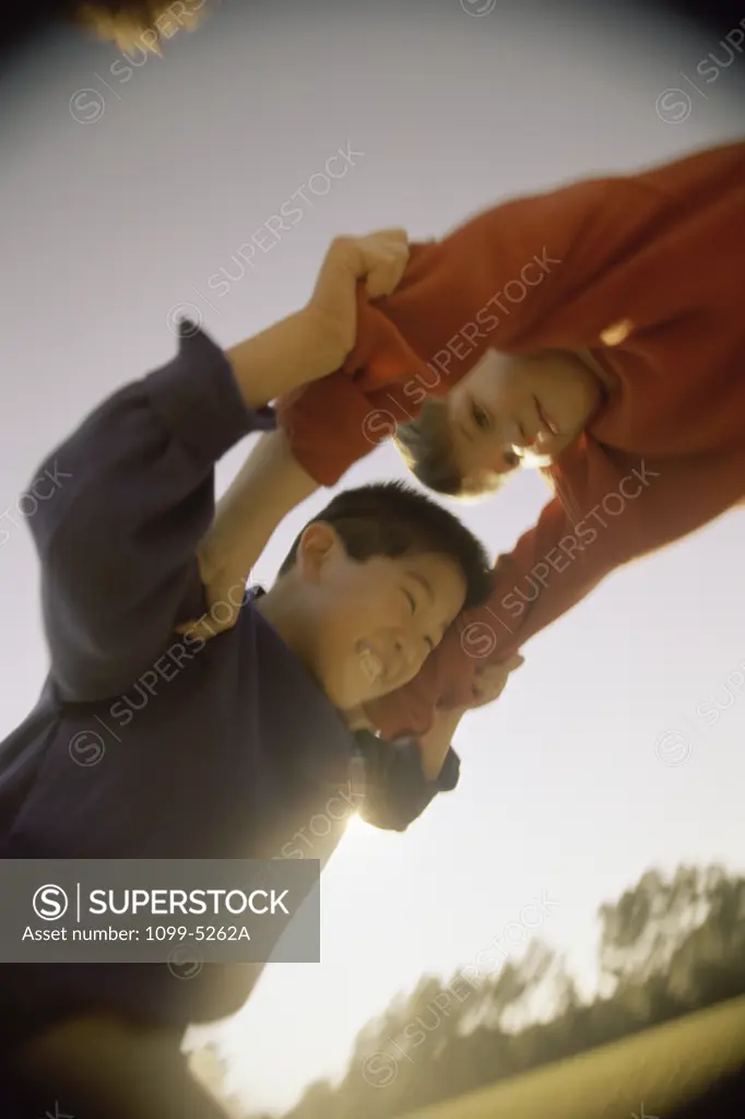 Low angle view of two boys fighting