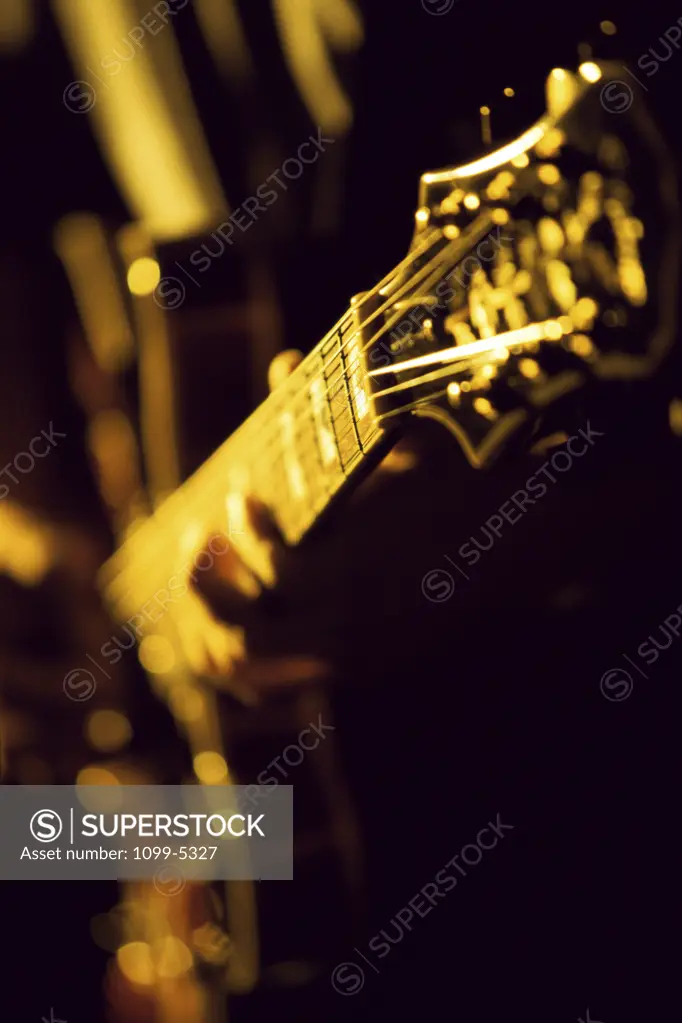 Close-up of a person playing an electric guitar