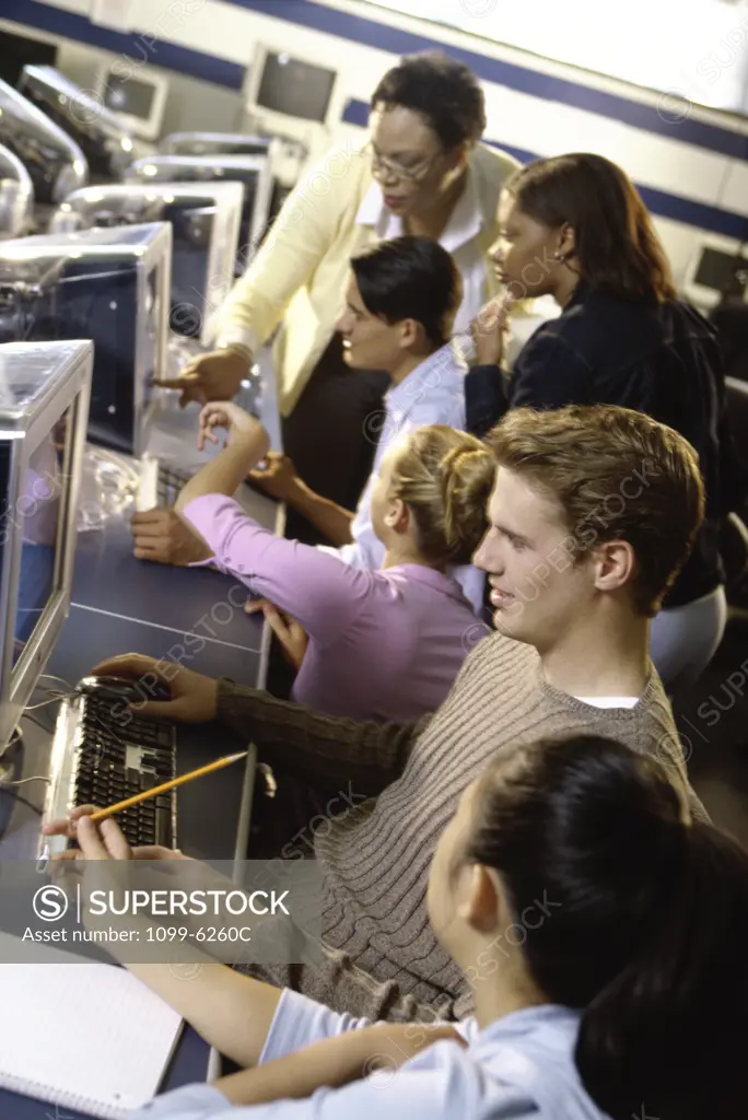 Female teacher and her students in a computer class