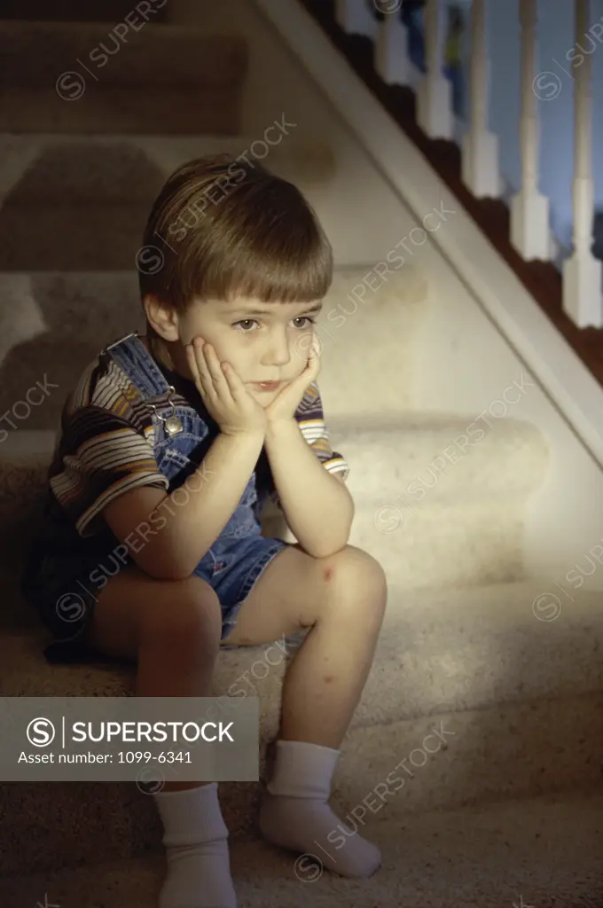 Boy sitting on stairs