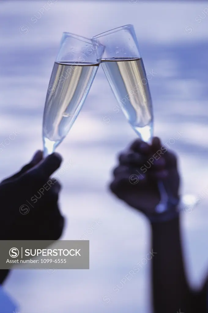 Two people holding champagne flutes