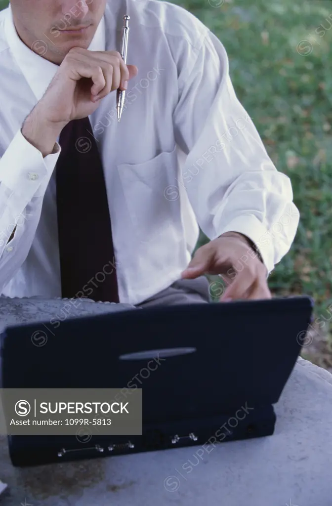 Businessman sitting in front of a laptop