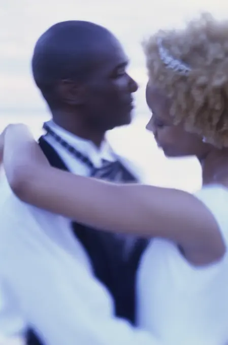 Side profile of a newlywed couple dancing