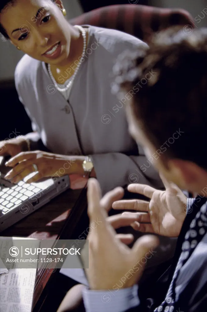 Businessman and a businesswoman talking in an office