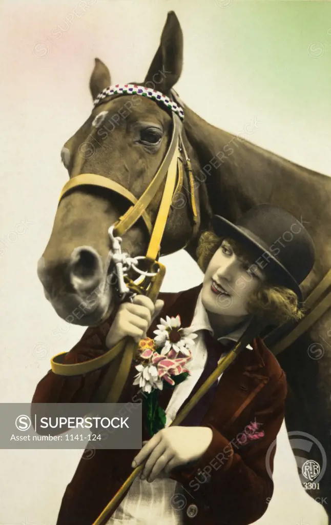 Female jockey standing with a horse