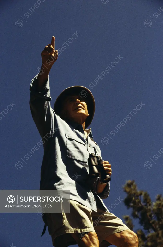 Low angle view of a senior man pointing ahead