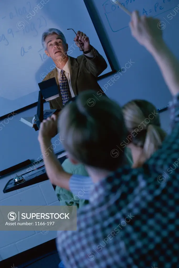 Male teacher explaining with the help of an overhead projector