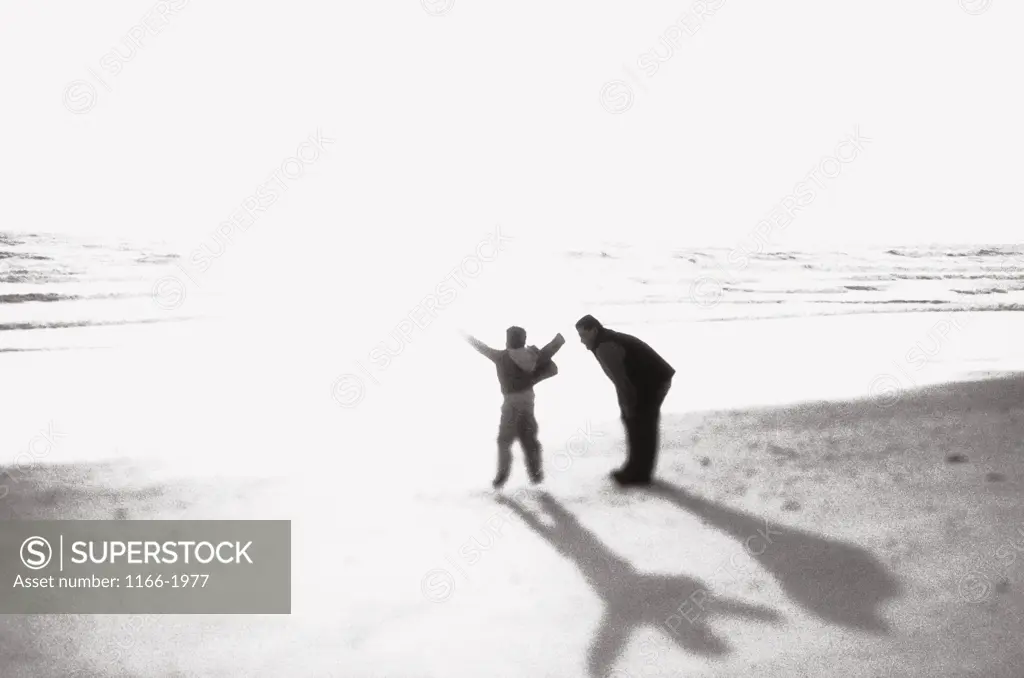 Father and his son on the beach