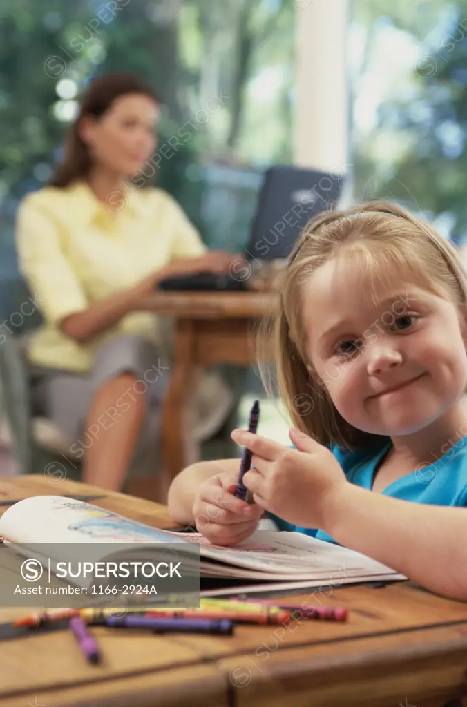 Portrait of a girl holding crayons