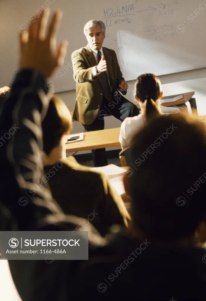 Male professor lecturing students in a classroom