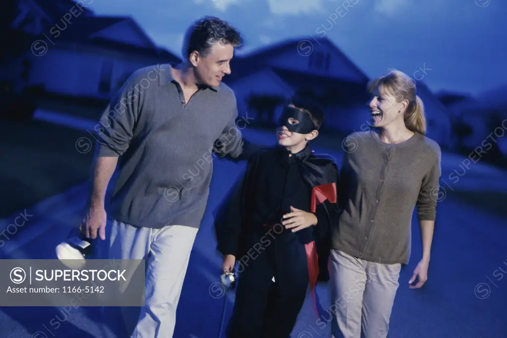 Parents trick or treating with their son