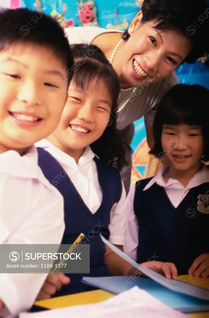 Teacher smiling with her students in a classroom