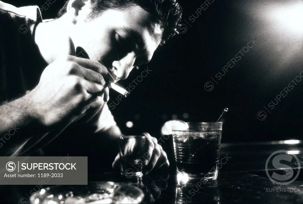 Side profile of a young man smoking a cigarette