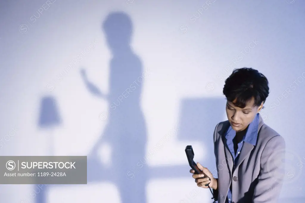 Businesswoman holding a telephone receiver