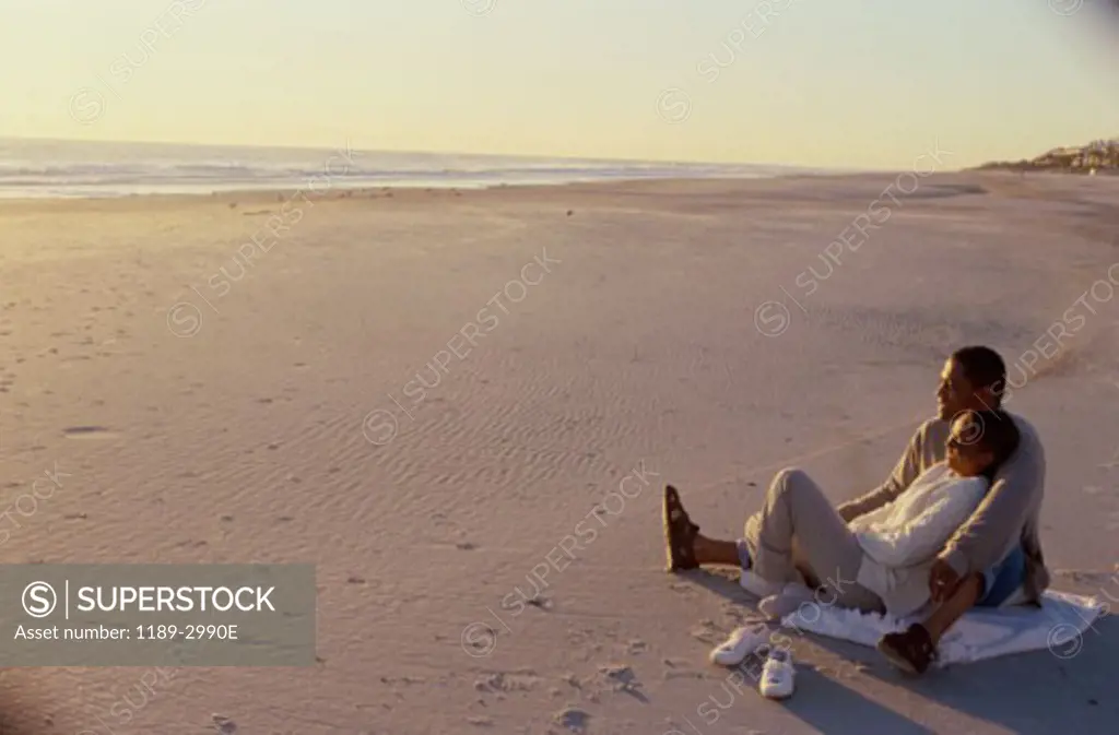 Young couple sitting on the beach