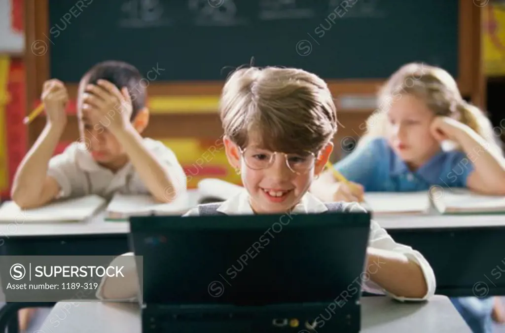 Girl using a laptop in a classroom